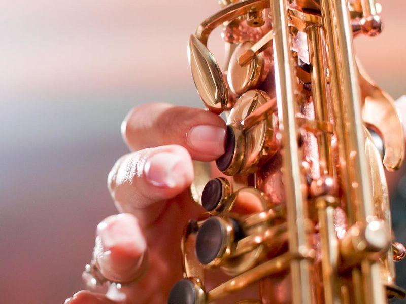 A closeup of someone playing a saxophone